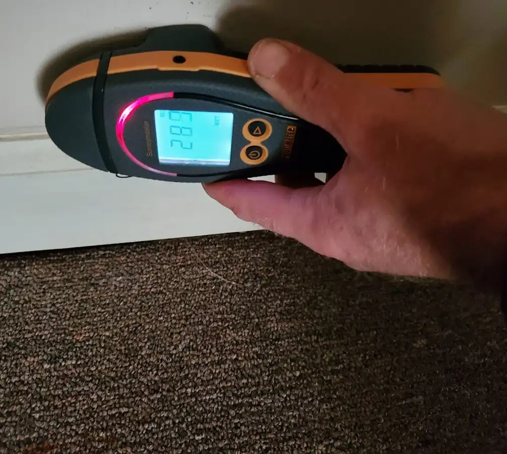 Moisture detection at baseboard during Storm Damage Restoration in Wonder Lake